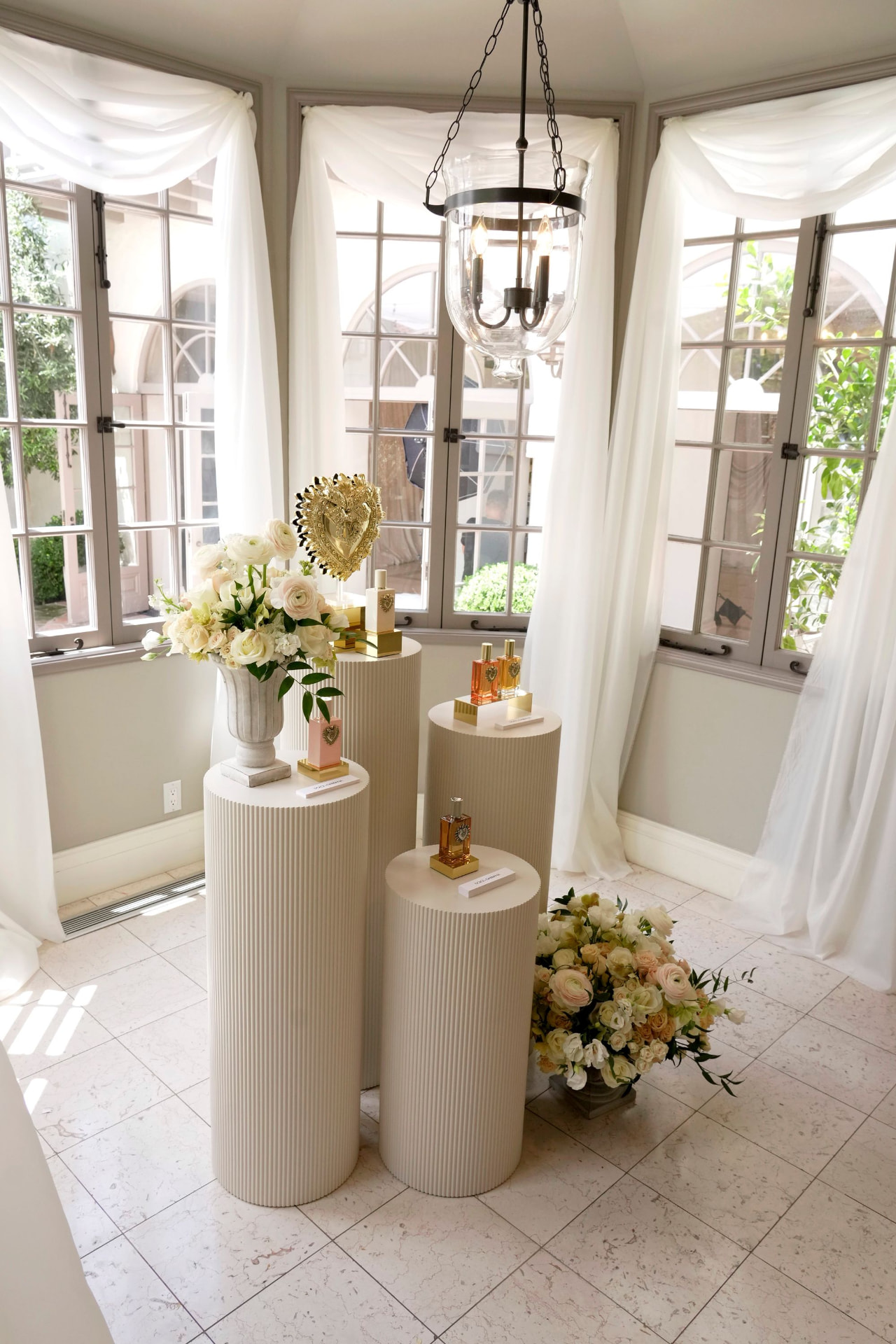 Fragrance display on plinths in a sunlit room
