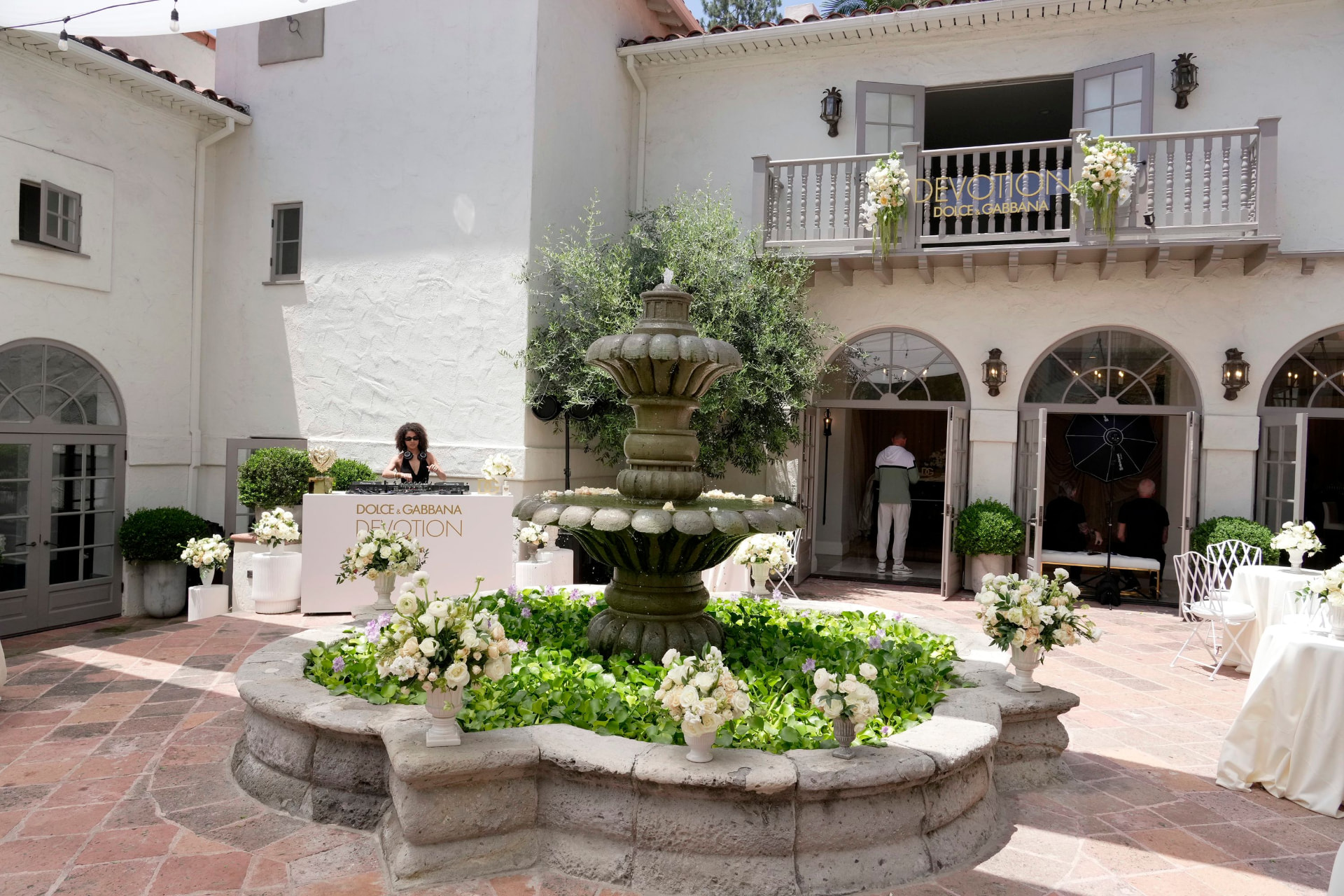 DJ performing beside the courtyard fountain