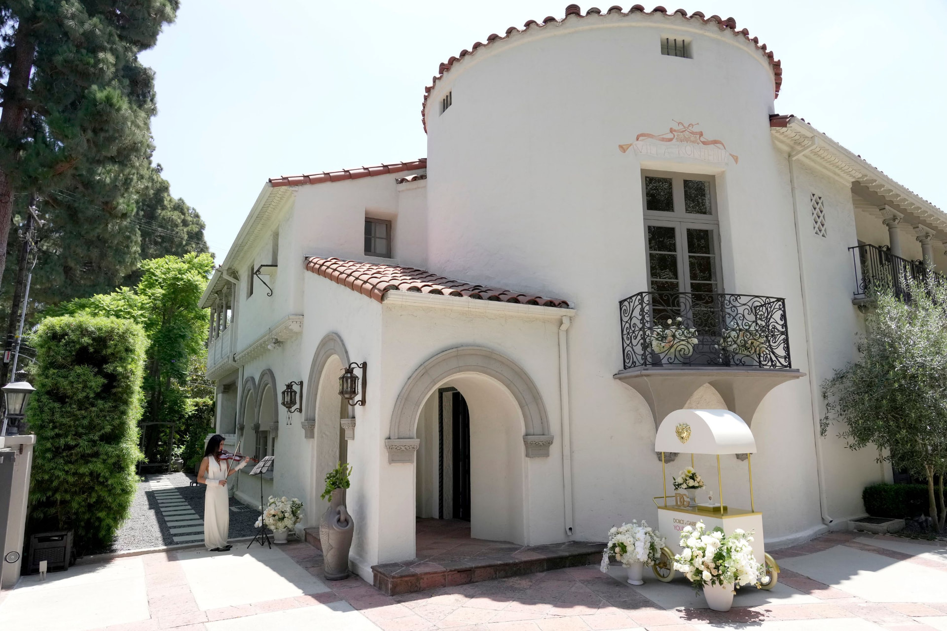 Villa Del Sol facade with violinist welcoming guests
