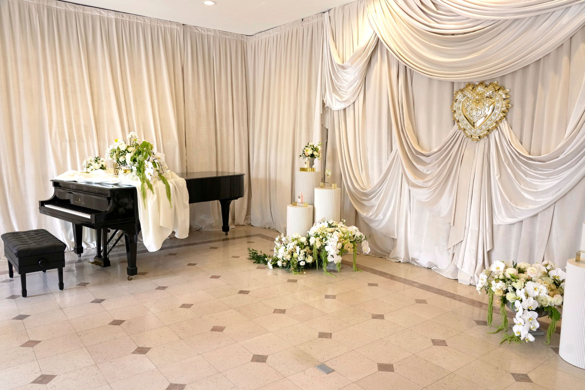Draped piano room with gold Devotion heart