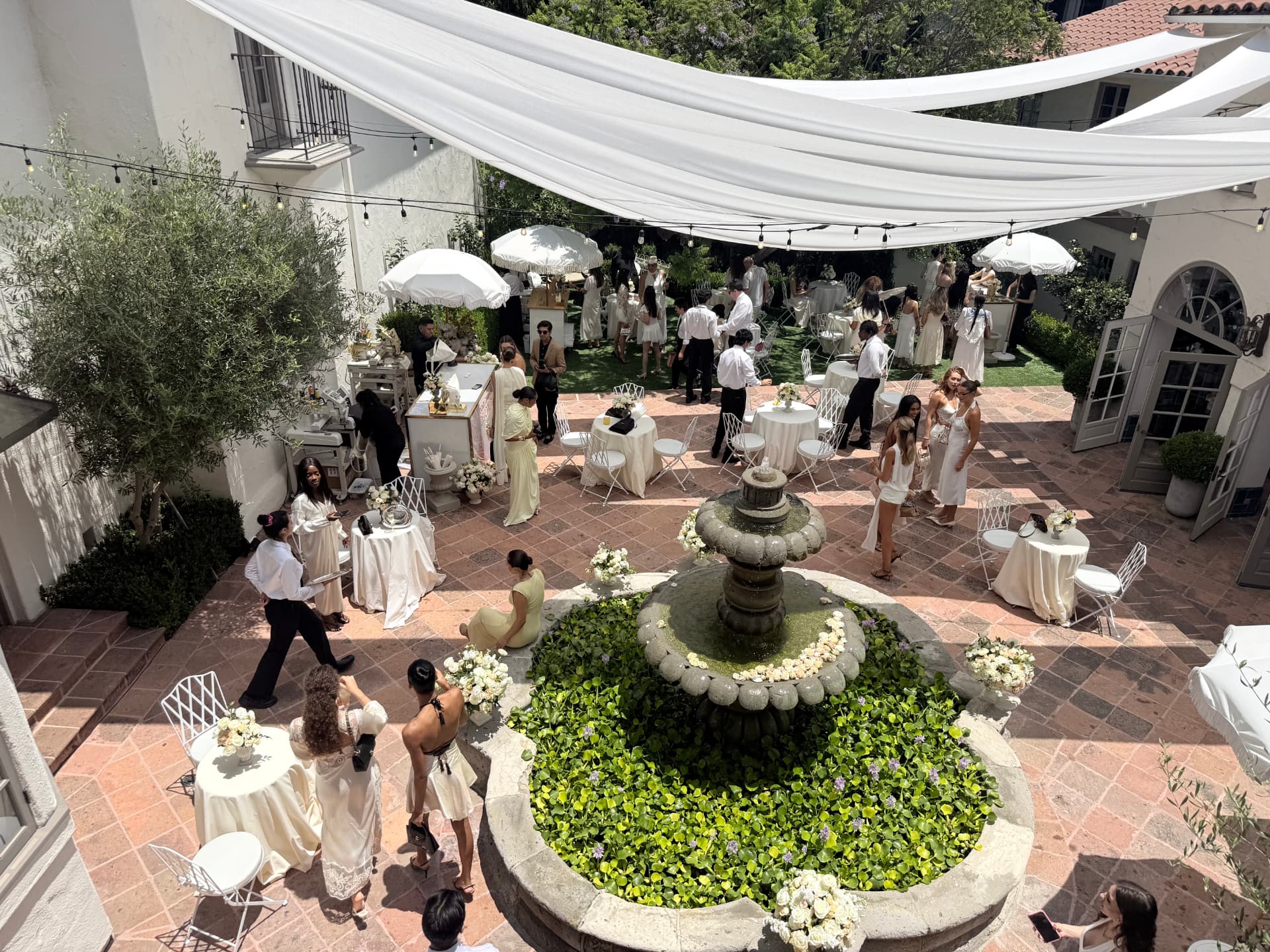 Aerial view of guests gathered around the courtyard fountain
