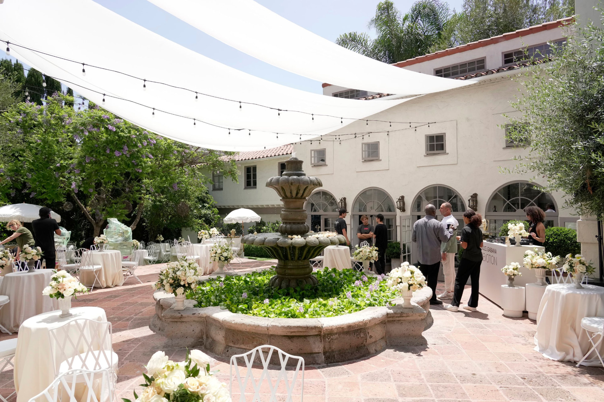 Courtyard set with shade sails and florals before guests arrive